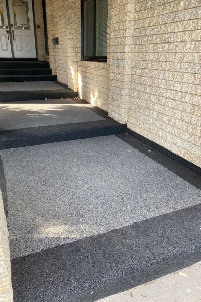 Rubber paved covered steps at the front door of a house